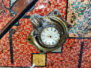 Vintage steampunk red travel box close up view of pocket watch detail