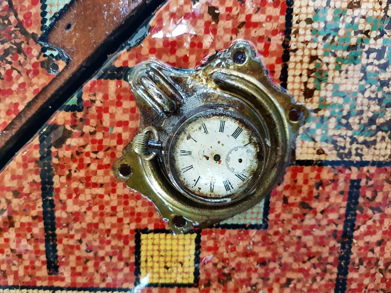 Vintage steampunk red travel box close up view of pocket watch detail