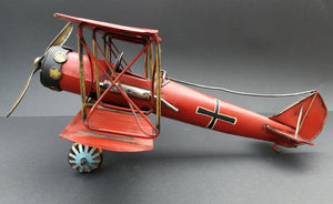 Tin aeroplane. Red and black. Hand made. Side view.