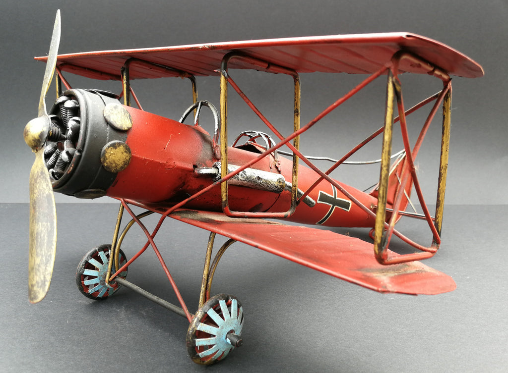 Tin aeroplane. Red and black. Hand made. 45 degree view.